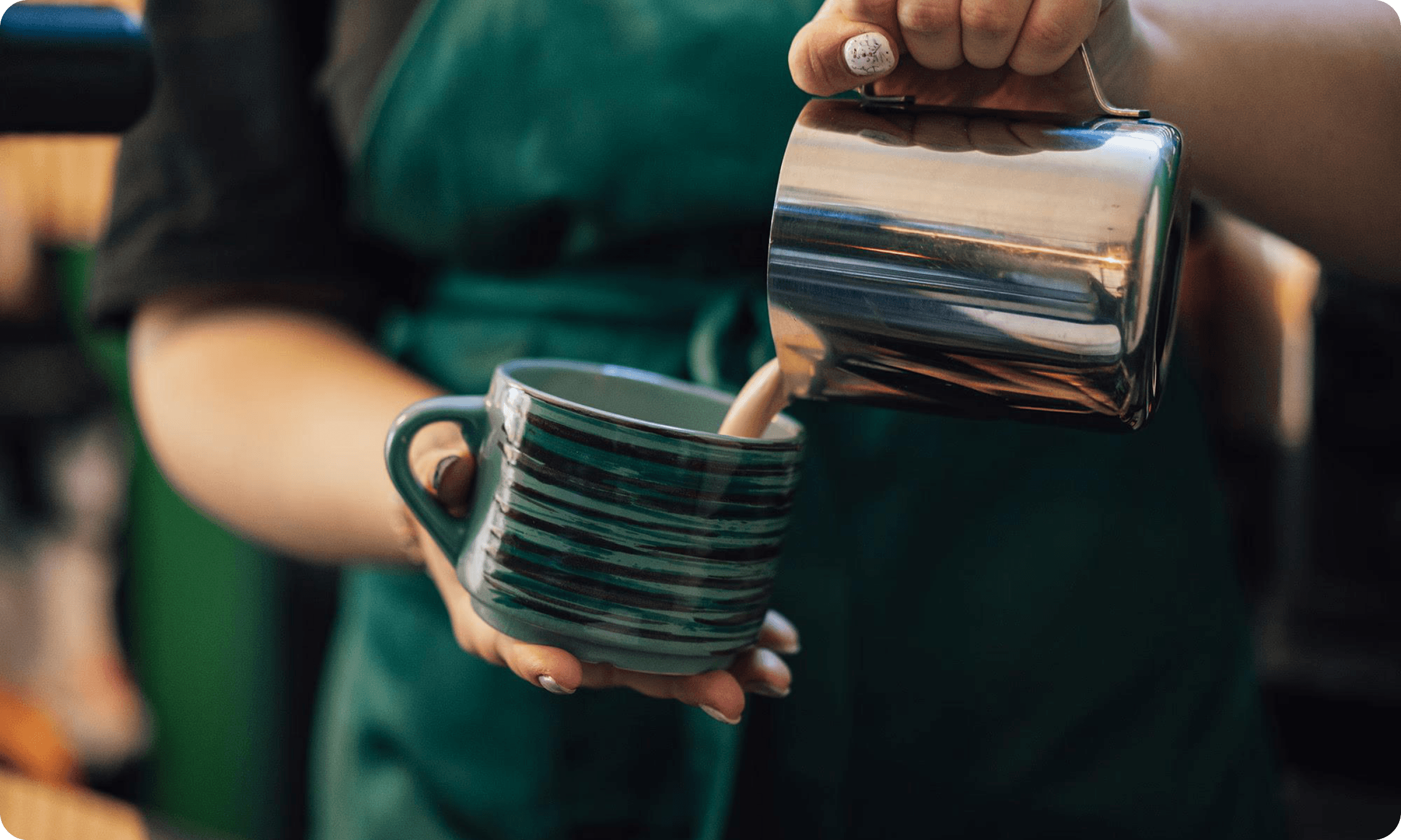 Barista pouring milk